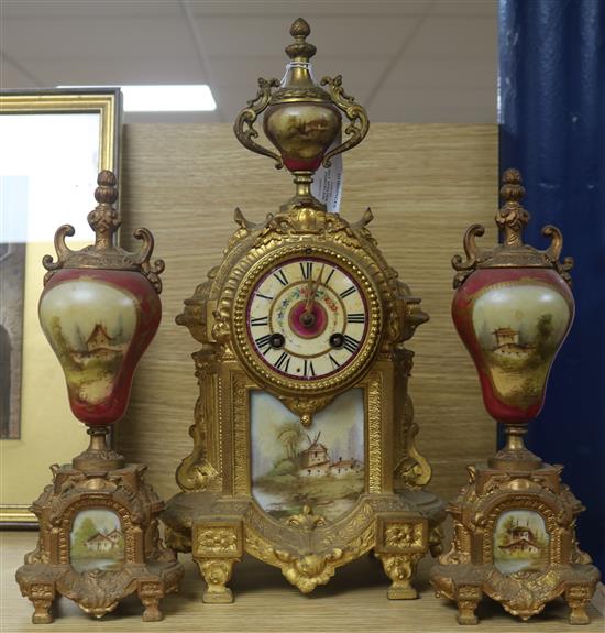 A gilt spelter and porcelain mounted clock garniture